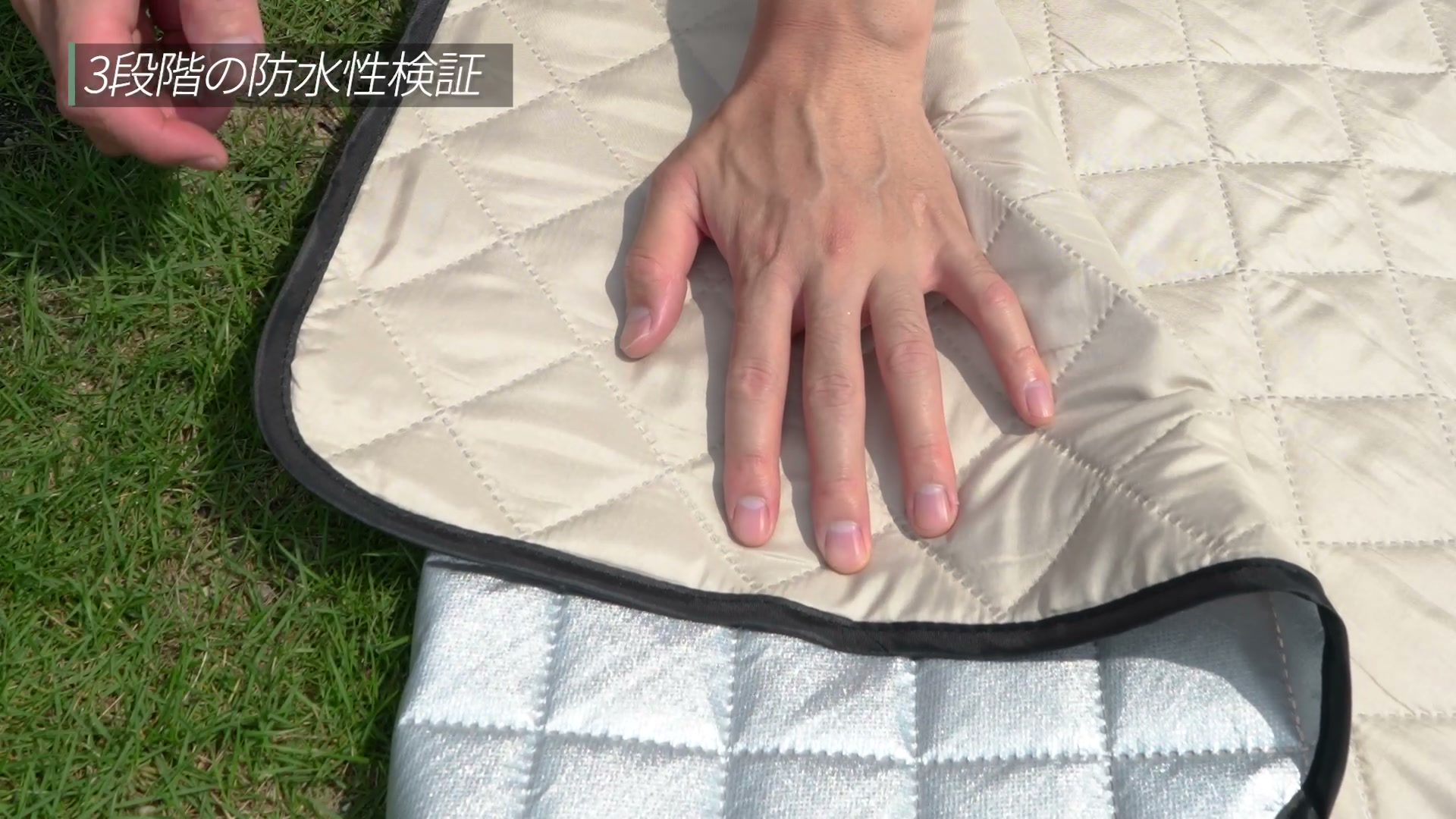 水を挟んだシートを手で押している様子